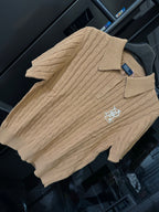 Ralph Lauren cable-knit polo shirt in beige, front three-quarter view with chest logo.