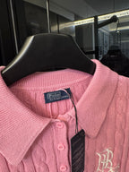 Pink cable-knit polo shirt neckline with button placket and RL emblem