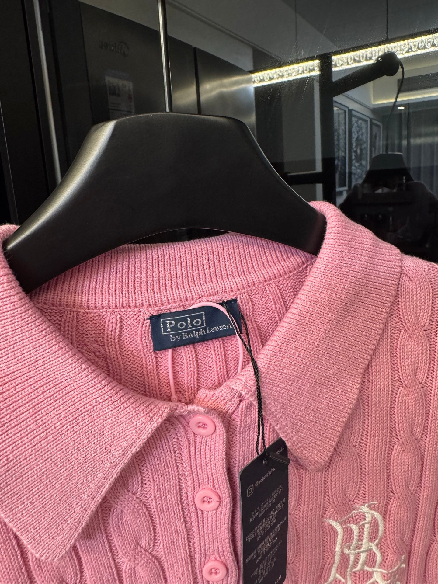 Pink cable-knit polo shirt neckline with button placket and RL emblem