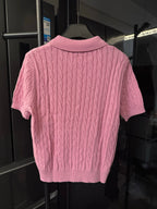 Back view of pink cable-knit polo shirt with ribbed collar and hem