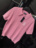 Pink cable-knit polo shirt with RL emblem, button placket, and hanging tag