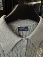 Gray knit polo sweater neckline with button placket and inner brand label