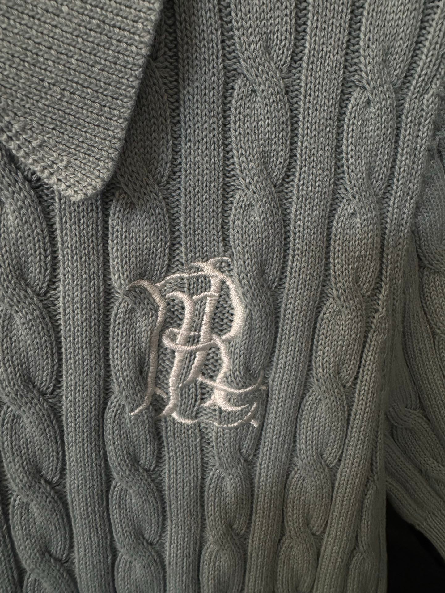 Embroidered logo on gray cable-knit polo sweater front