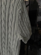 Gray cable-knit polo sweater side view with textured cable pattern
