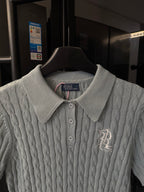 Gray cable-knit polo sweater collar and button placket with embroidered chest logo