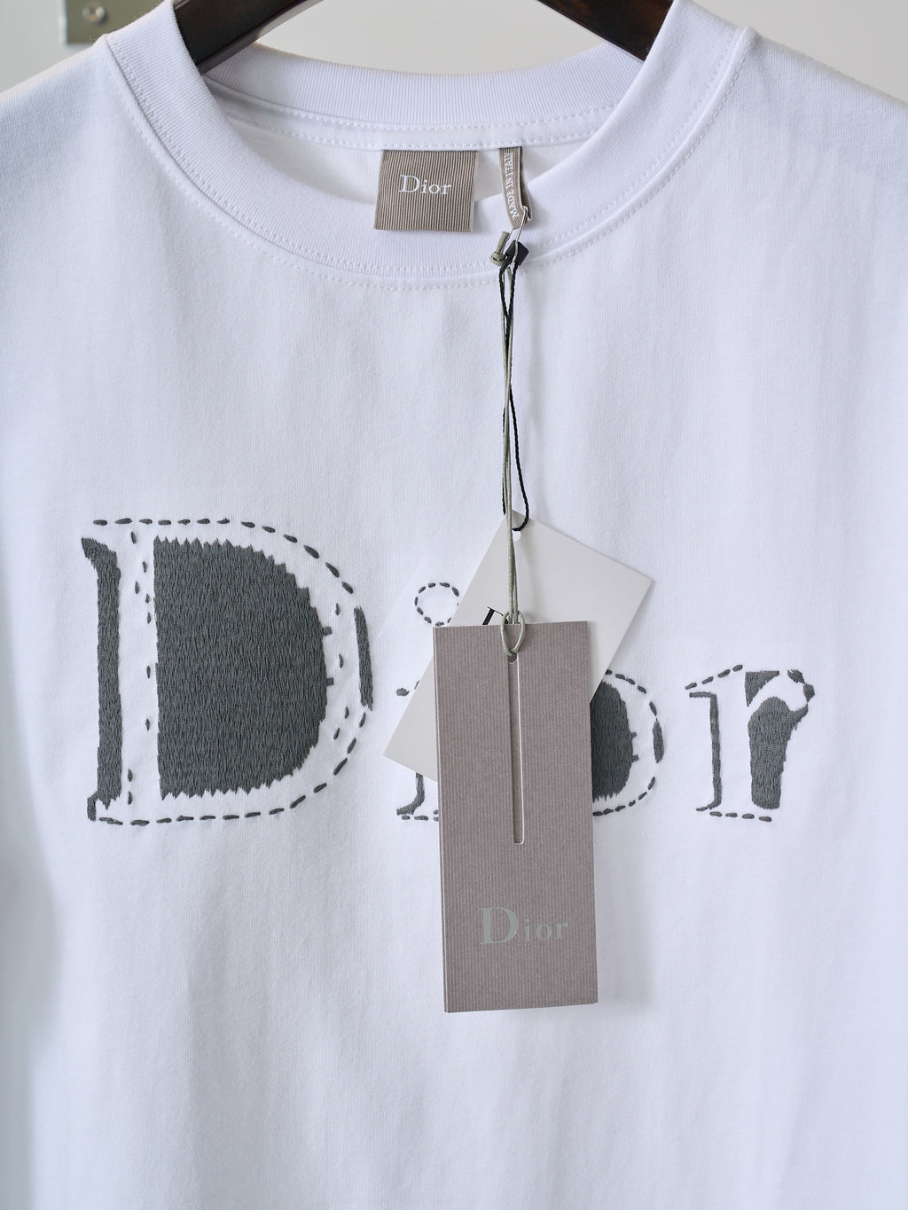 White Dior T-shirt with Dior print and attached brand tag