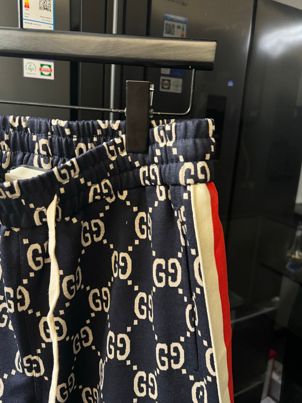 Gucci pants with navy GG monogram print and red-and-cream side stripe