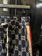 Gucci pants with navy GG monogram print and red-and-cream side stripe