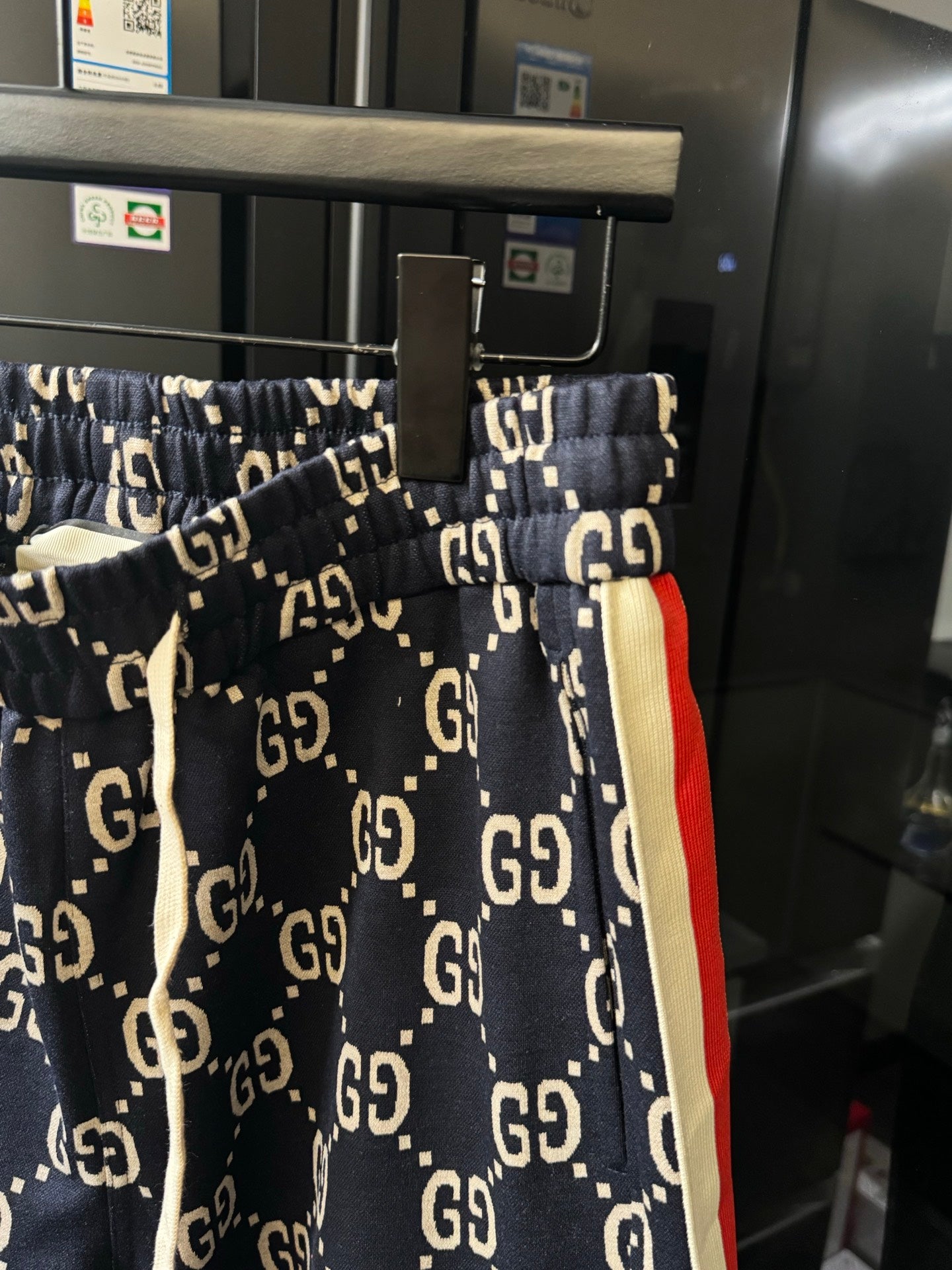 Gucci pants with navy GG monogram print and red-and-cream side stripe