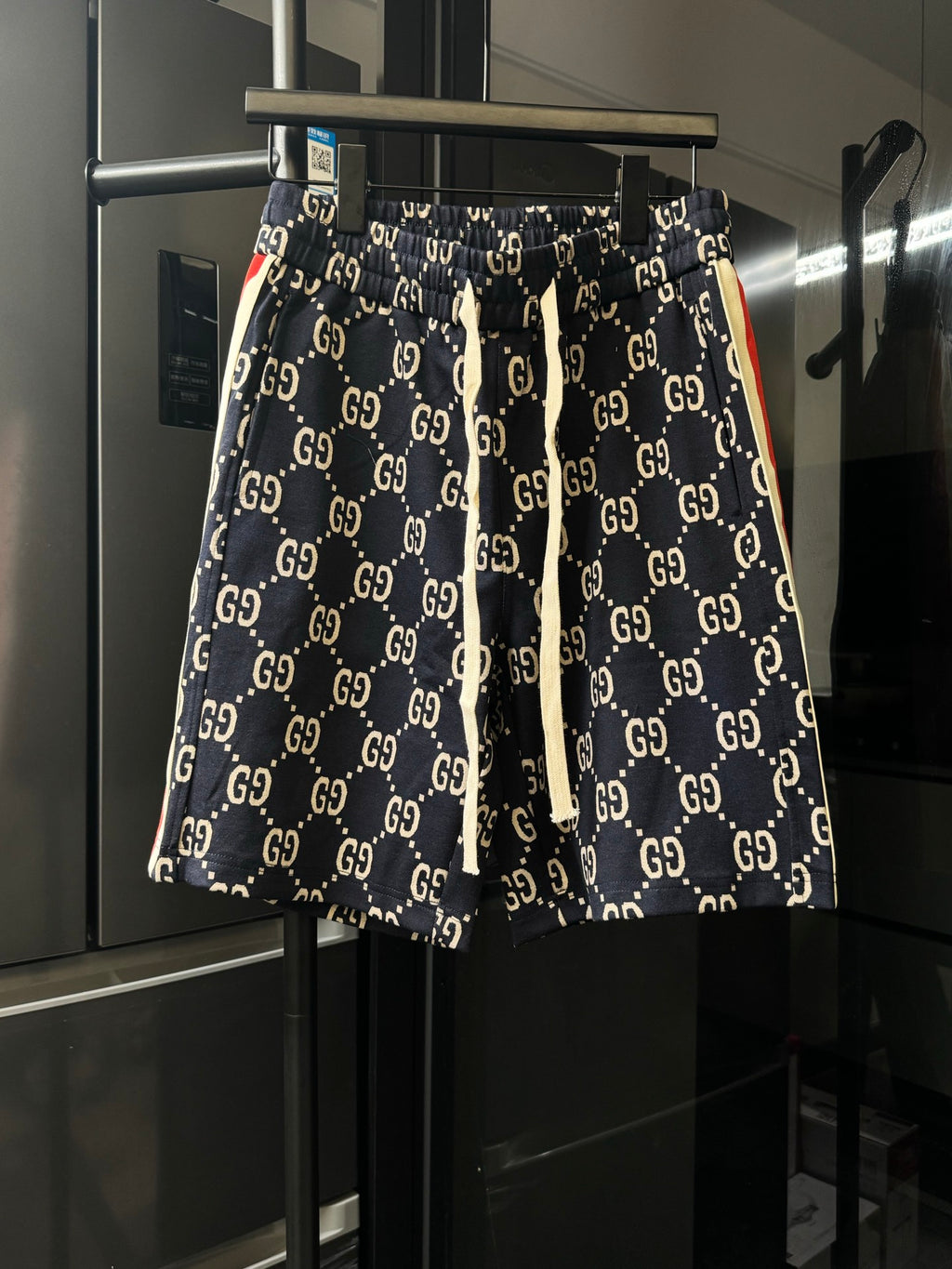 Gucci pants with navy GG monogram print, elastic waistband and drawstring ties