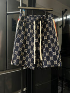 Gucci pants with navy GG monogram print, elastic waistband and drawstring ties