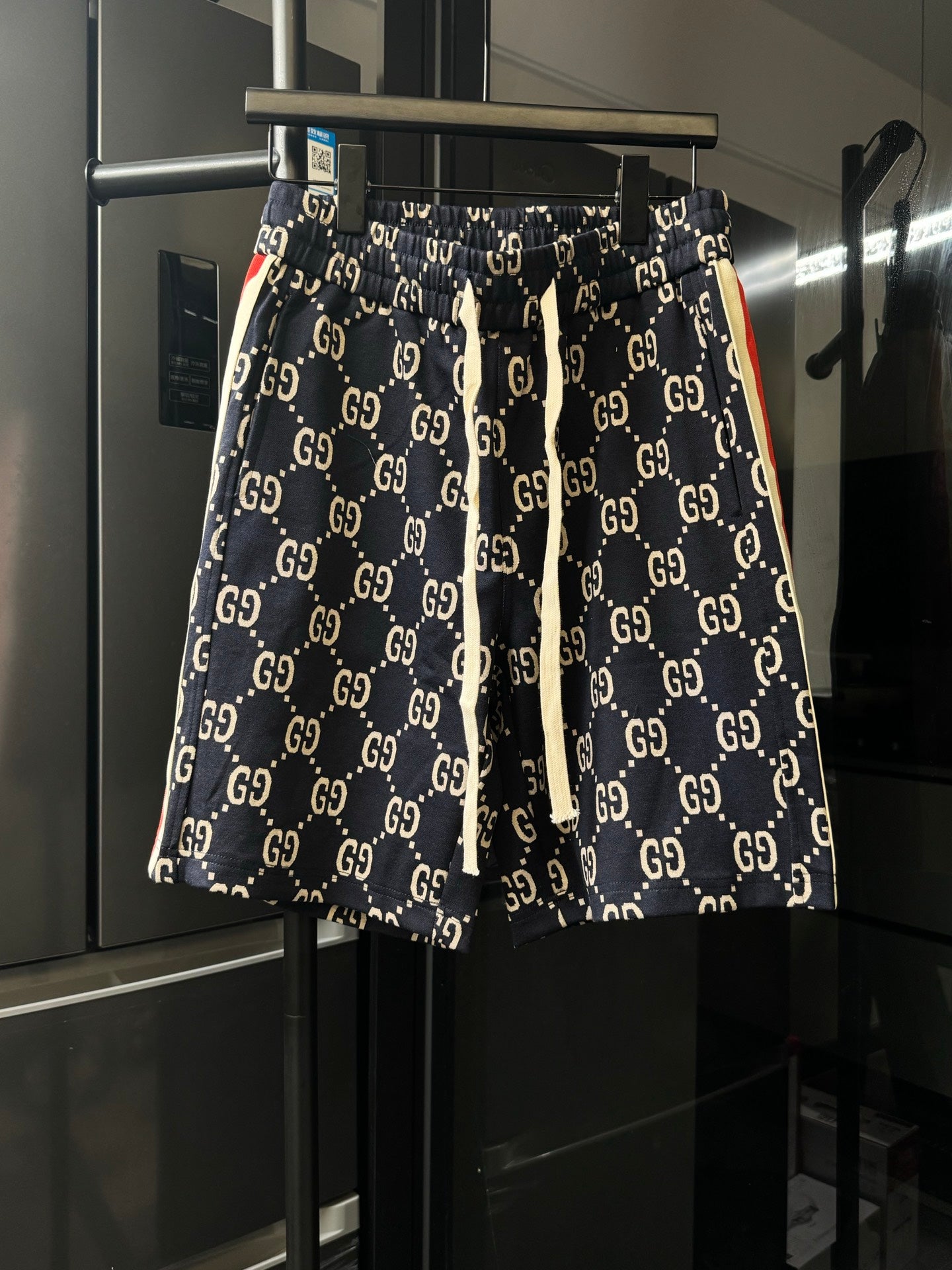 Gucci pants with navy GG monogram print, elastic waistband and drawstring ties