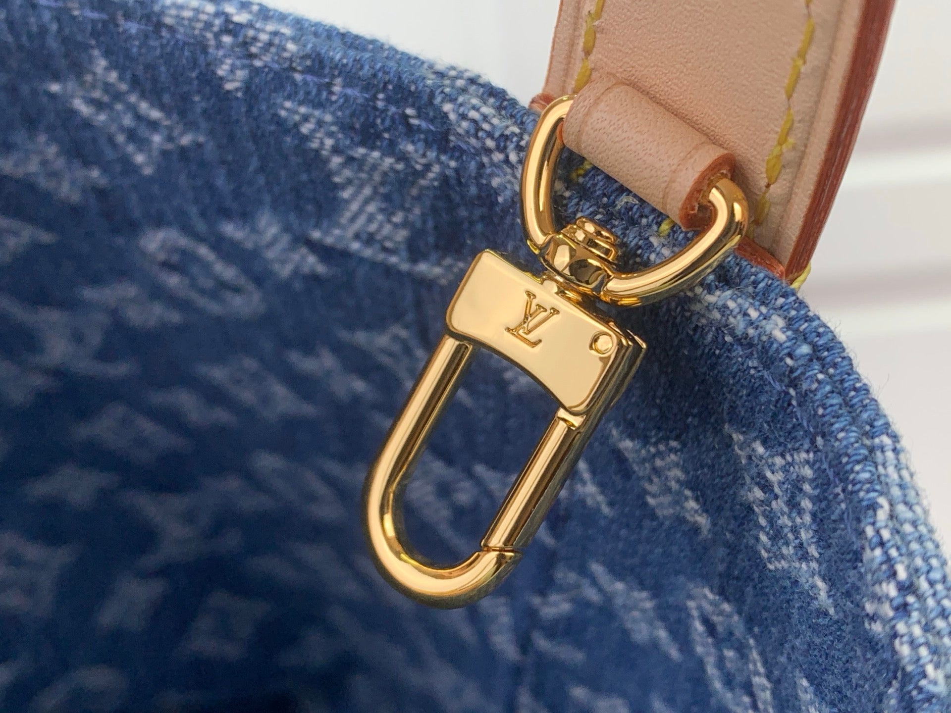 Louis Vuitton gold-tone carabiner clasp on tan strap with blue monogram
