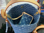 Louis Vuitton monogram tote bag with tan handles, gold hardware, and front pouch