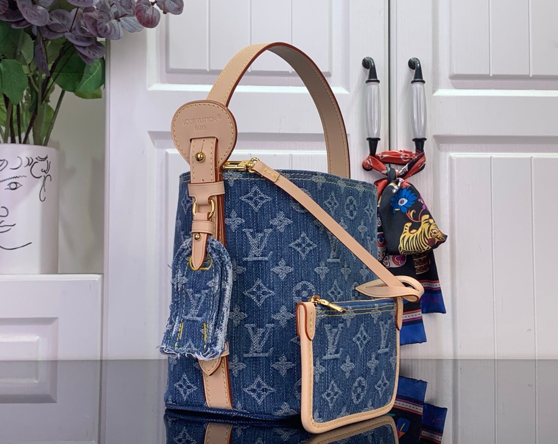 Louis Vuitton monogram denim-style tote with crossbody strap and tan leather trim