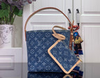 Louis Vuitton monogram denim-style bucket tote with tan strap and matching pouch