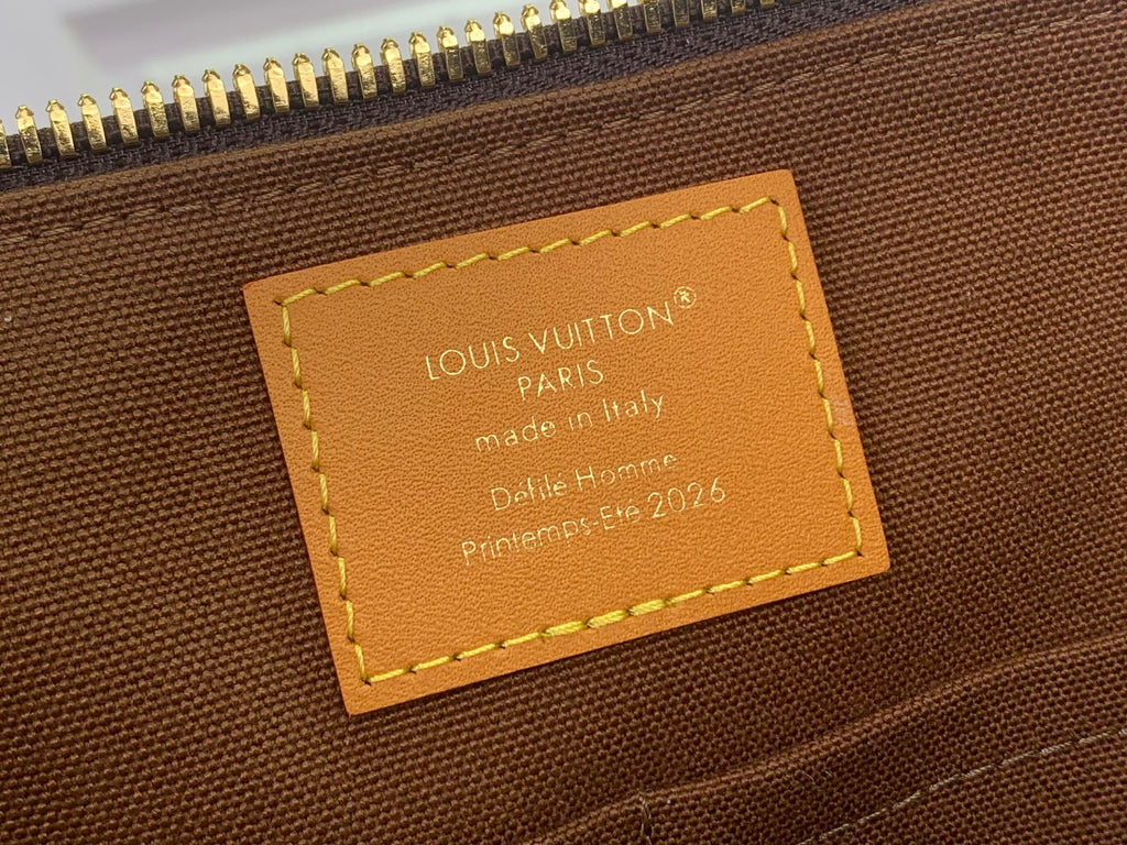Louis Vuitton monogram bag interior leather label with stamped text and stitching.
