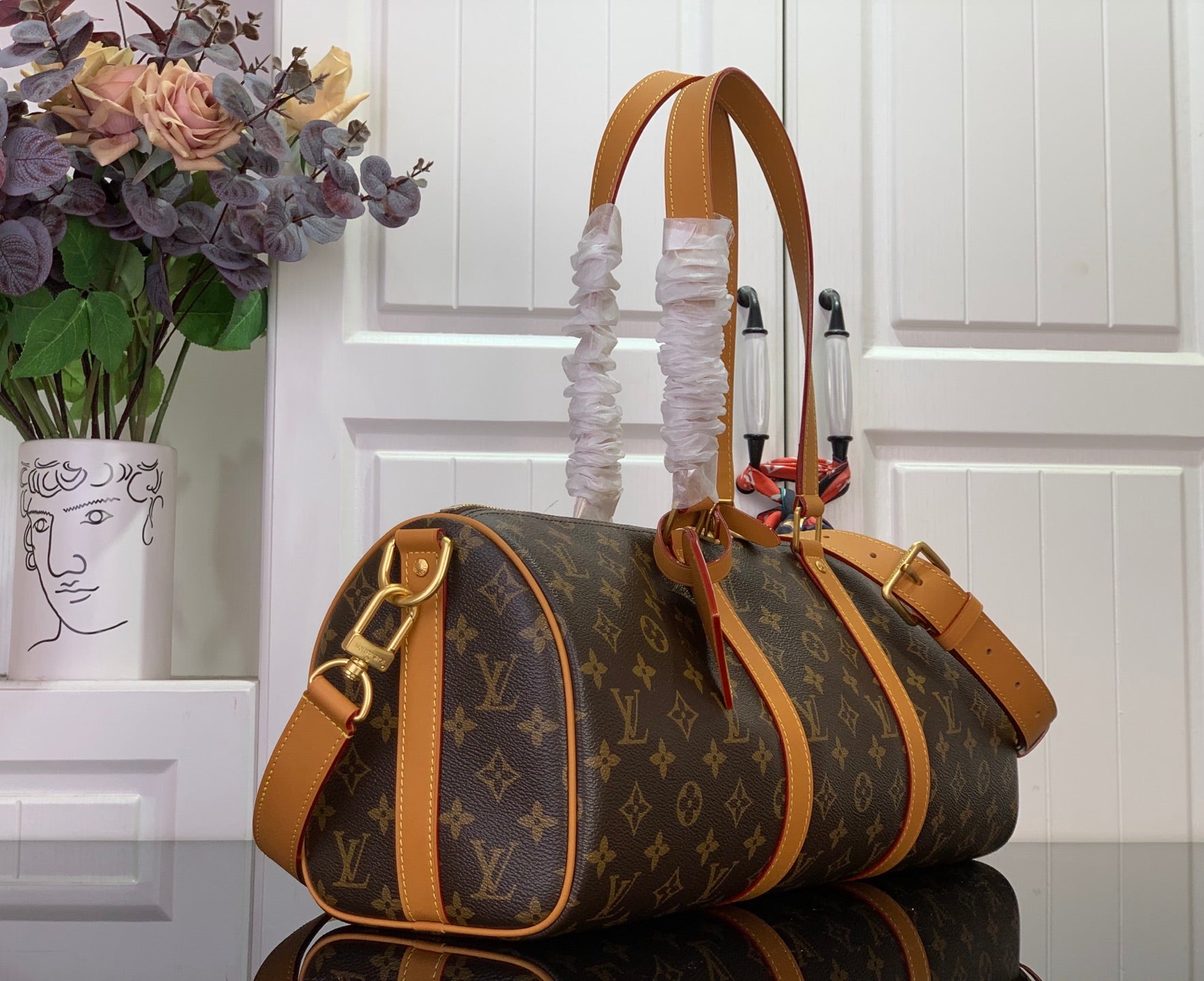 Louis Vuitton monogram duffel bag, tan leather handles and detachable shoulder strap.