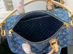 Louis Vuitton blue monogram handbag interior with zipper opening and gold trim hardware