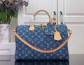 Louis Vuitton blue monogram handbag with tan leather handles and gold hardware