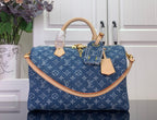 Louis Vuitton blue monogram handbag with tan leather handles and gold hardware