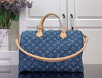 Louis Vuitton blue monogram handbag with tan top handles and gold clasp hardware