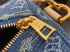 Louis Vuitton metal hardware charm with gold clasp on denim zipper