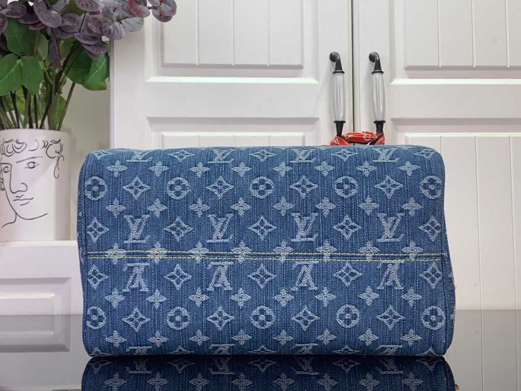 Louis Vuitton blue monogram handbag back view with stitched texture and gold hardware
