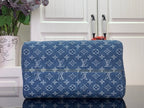 Blue monogram duffel bag with patterned exterior and rounded silhouette