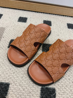 Gucci tan monogram slide sandals with open toe, dark edge trim, flat sole