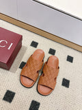 Gucci monogram slide sandals in tan with open toe and black-trimmed straps