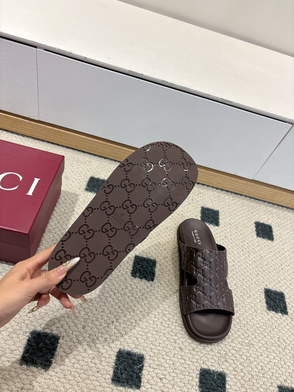 Gucci dark brown embossed slide sandals with open toe and logo footbed