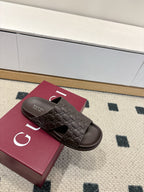 Gucci dark brown embossed slide sandals with open toe and logo strap