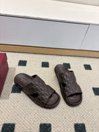 Gucci dark brown embossed slide sandals, front view with open toe