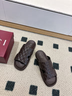 Gucci dark brown embossed slide sandals, two shoes shown with open toe