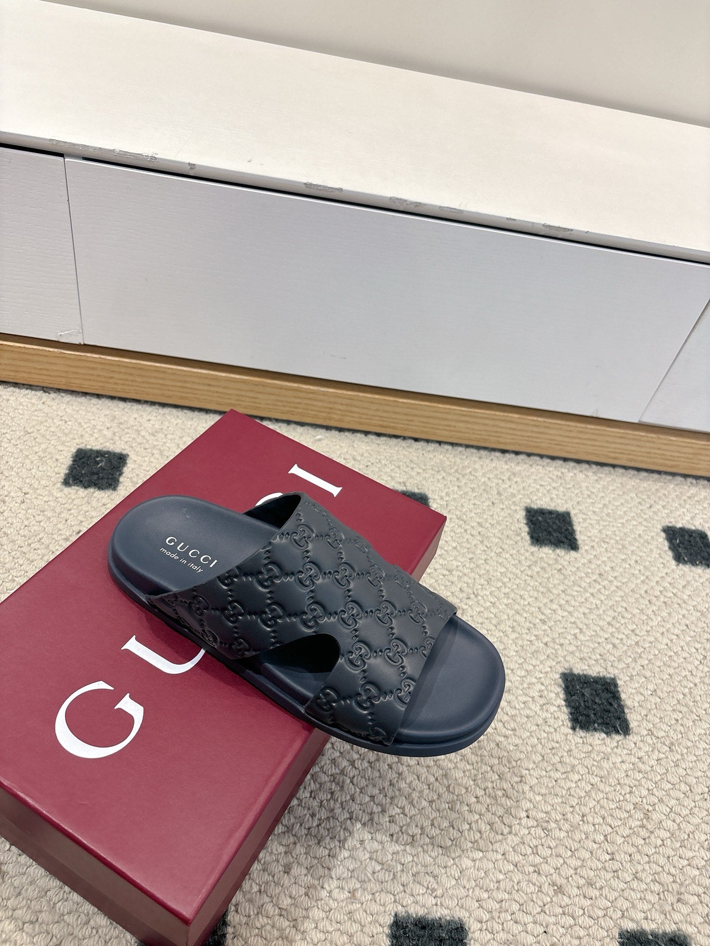 Gucci dark blue GG embossed slide sandals with wide strap and open toe