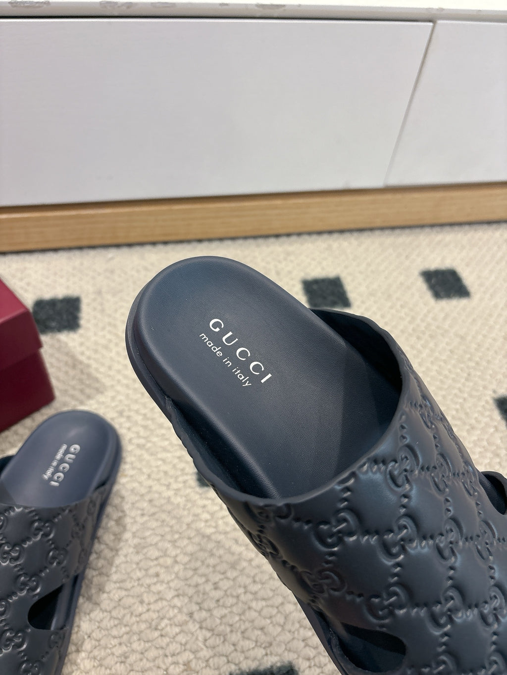 Gucci dark blue slide sandal with GG embossed upper and branded footbed