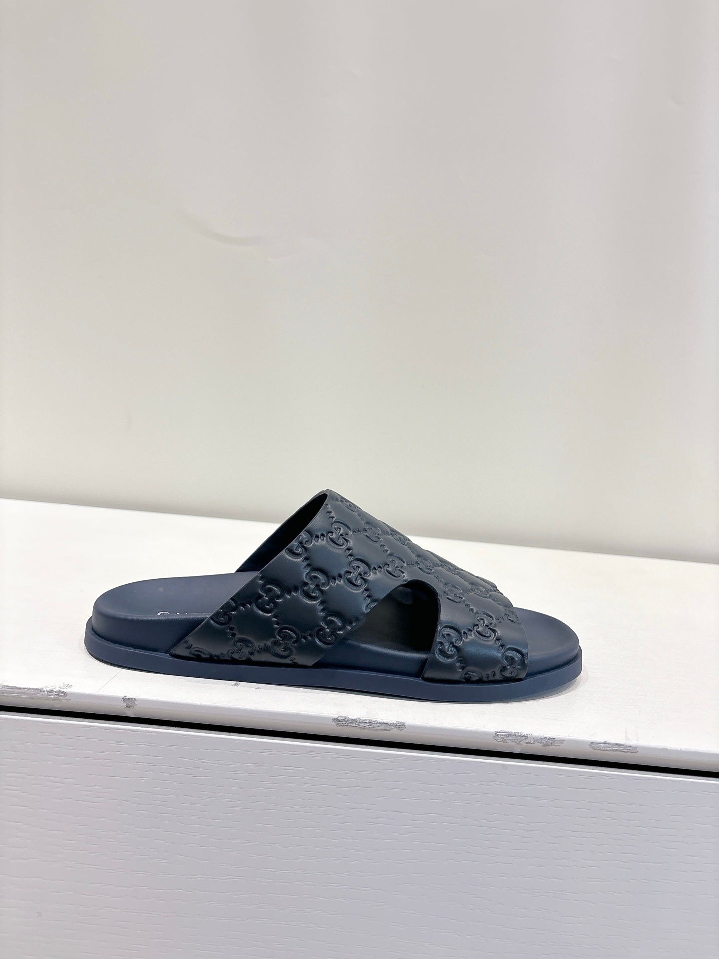 Gucci dark blue GG embossed slide sandal with open toe and cushioned footbed