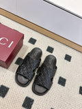 Gucci black slide sandals with embossed monogram strap