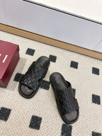 Gucci black slide sandals with embossed monogram strap and open toe