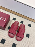 Burgundy Gucci slide sandals with textured GG logo upper and open-toe design
