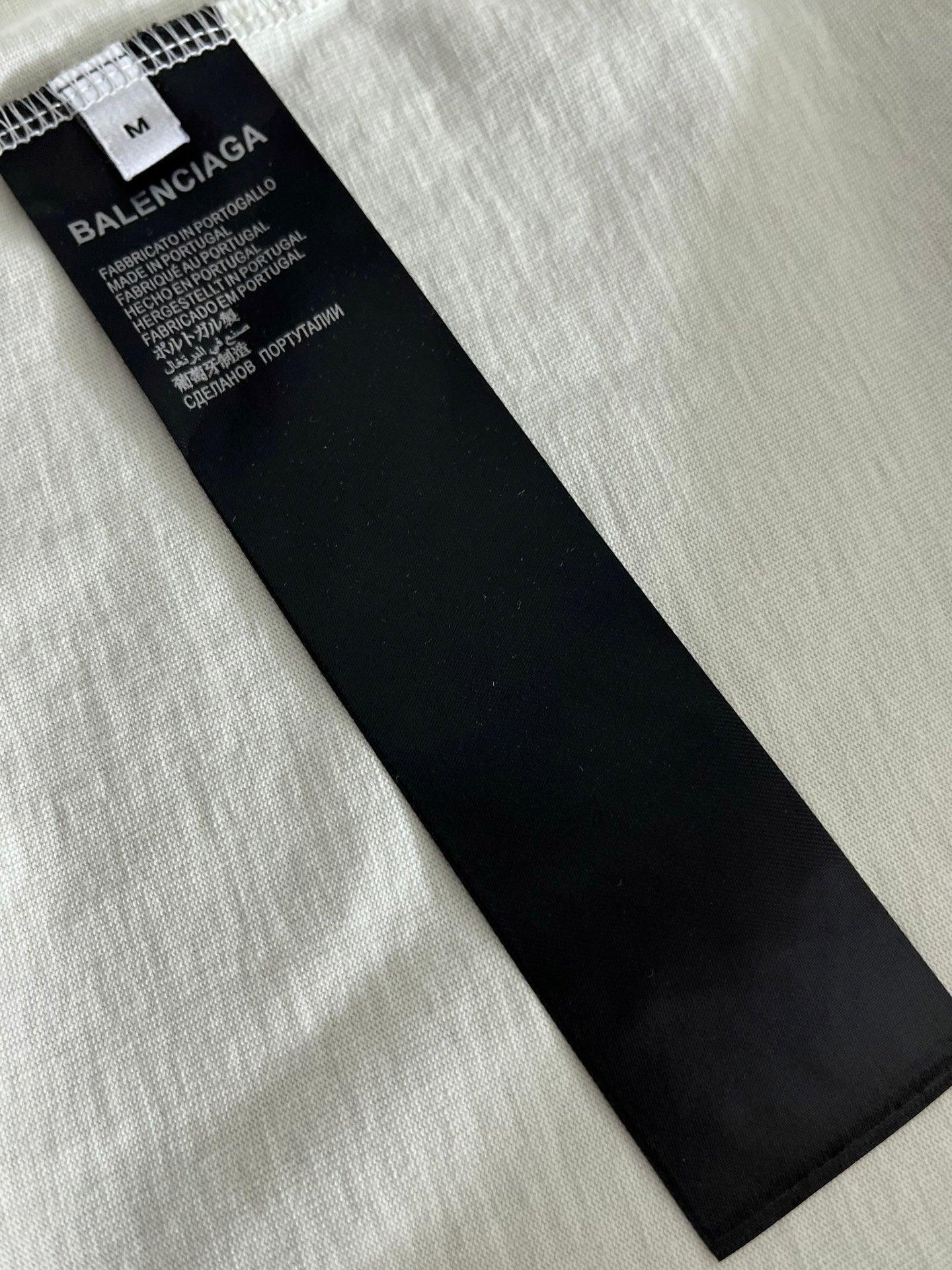 Black Balenciaga size and care label inside white T-shirt
