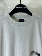 White Balenciaga T-shirt close-up: crew neck with logo print