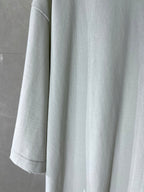 White Balenciaga T-shirt showing sleeve and curved hem, plain body