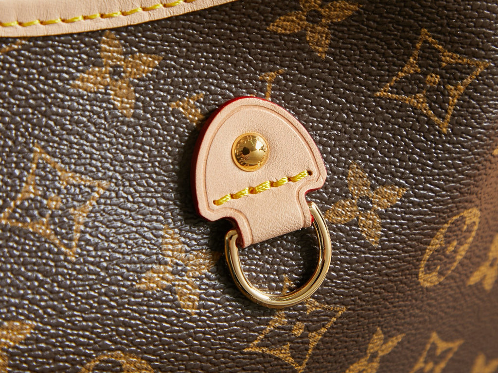 Louis Vuitton monogram bag charm key ring with gold clasp on brown canvas