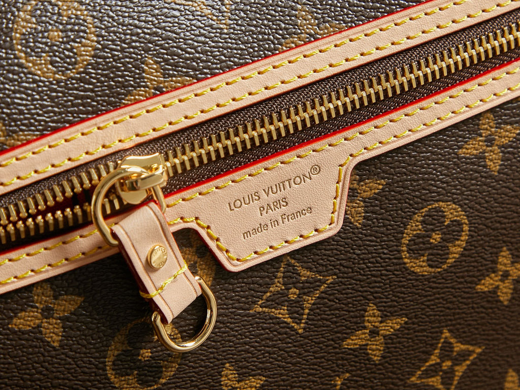 Louis Vuitton monogram bag zipper close-up with gold hardware and label patch