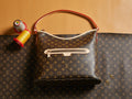 Louis Vuitton monogram hobo bag with red piping, top handle and front clasp pocket