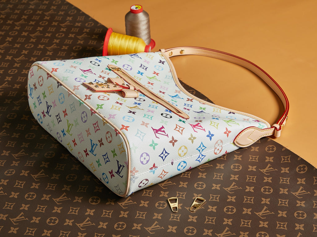 Multicolor monogram handbag with long strap, top handle, and front zipper pull
