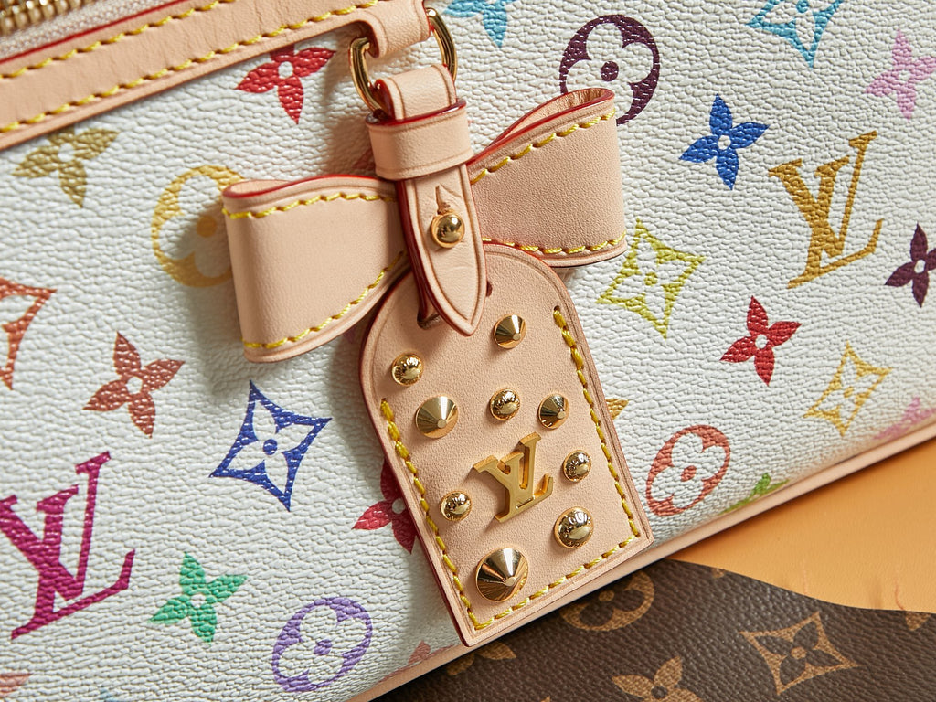 Multicolor monogram handbag close-up of snap lock and studded leather strap