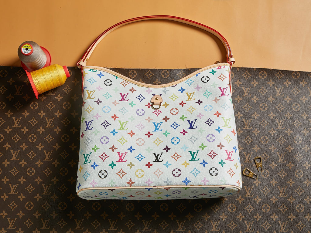 Multicolor monogram handbag with top handle and front panel with hanging charm